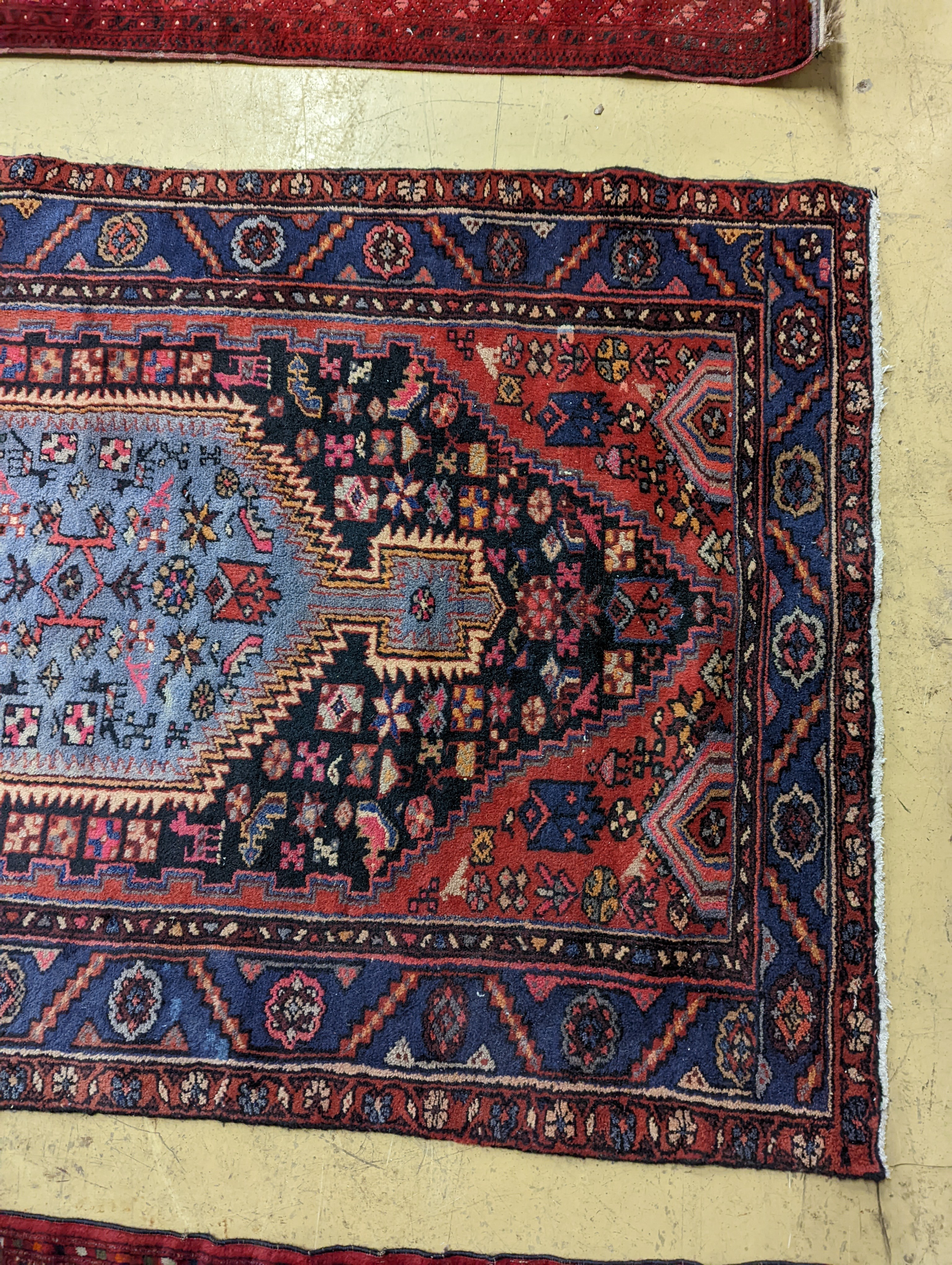 A Hamadan blue ground floral rug and a smaller Caucasian design blue ground rug, larger 210 x 130cm